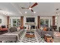 Cozy living room with a brick fireplace, comfortable sofas, and a patterned rug for a relaxed atmosphere at 11822 S Coconino St, Phoenix, AZ 85044