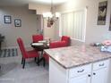 Cozy dining area featuring red chairs, a chandelier, and stylish decor at 12222 N Paradise Village S Pkwy # 325, Phoenix, AZ 85032