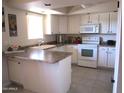 Functional kitchen with modern appliances and a convenient island at 12222 N Paradise Village S Pkwy # 325, Phoenix, AZ 85032