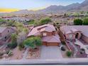 Stunning aerial view of the home in a desert neighborhood surrounded by mountains and scenic views at 14056 E Desert Cove Ave, Scottsdale, AZ 85259