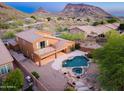 Aerial view of a home's backyard featuring a pool, spa, and mountain views at 14056 E Desert Cove Ave, Scottsdale, AZ 85259
