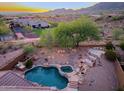 Aerial view of backyard with sparkling pool and well-maintained landscaping and fence at 14056 E Desert Cove Ave, Scottsdale, AZ 85259