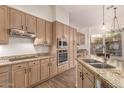 Bright kitchen features stainless appliances, ample cabinetry and stone countertops at 14056 E Desert Cove Ave, Scottsdale, AZ 85259