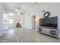 Open living area with vaulted ceilings, ceiling fan, and access to kitchen and seating area at 1519 E Indian Wells Dr, Chandler, AZ 85249