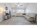 Spacious living room with white leather sectional, stylish decor, and bright natural light at 1519 E Indian Wells Dr, Chandler, AZ 85249