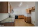 Kitchen with oak cabinets, laminate countertops, and modern appliances at 15701 N Bonow Dr, Surprise, AZ 85374