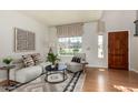 Bright living room with wooden floors, natural light from large windows, and modern décor at 16823 S 24Th Pl, Phoenix, AZ 85048
