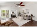 Bright living room with vaulted ceilings, ceiling fan, stylish furnishings, and access to the backyard at 18219 N 19Th St, Phoenix, AZ 85022