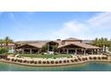 Spacious community clubhouse with lake views, outdoor seating, and manicured lawn at 25030 N 172Nd Ln, Surprise, AZ 85387