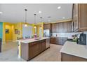 Modern kitchen with stainless steel appliances, a center island, and dark wood cabinets at 25030 N 172Nd Ln, Surprise, AZ 85387