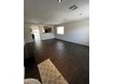 Spacious living room featuring dark hardwood flooring and neutral paint at 25862 W North Star Pl, Buckeye, AZ 85326