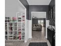 Open-concept entry with decorative shelving and view to a cozy living room bathed in natural light at 30639 N Dorado Ct, Queen Creek, AZ 85144