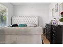 Bright bedroom featuring a large tufted headboard, and neutral color palette at 3107 N 79Th Ave, Phoenix, AZ 85033