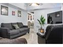 Cozy living room with comfortable seating, tiled floor, and a bright, airy atmosphere at 3107 N 79Th Ave, Phoenix, AZ 85033