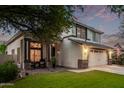 Well-maintained two-story home with a lush green lawn, a two-car garage, and inviting front entrance at 3466 E Bruce Ave, Gilbert, AZ 85234