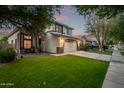 Inviting two-story home with a well-manicured lawn, driveway, and two-car garage at 3466 E Bruce Ave, Gilbert, AZ 85234