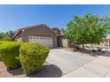 Inviting single-level home with a well-maintained front yard and a spacious driveway leading to the garage at 3507 E Alfalfa Dr, Gilbert, AZ 85298