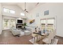 Bright living room featuring high ceilings, brick floors, a fireplace, and modern furnishings at 4225 N 21St St # 22, Phoenix, AZ 85016