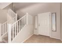 Home foyer with a staircase and tile flooring, creating a welcoming entryway at 45071 W Portabello Rd, Maricopa, AZ 85139