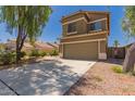 Two-story home featuring a neutral color scheme, concrete driveway, and a two-car garage at 45071 W Portabello Rd, Maricopa, AZ 85139
