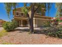 Two-story home features a well-manicured lawn and desert landscaping around the property at 45071 W Portabello Rd, Maricopa, AZ 85139