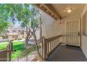 Exterior view from the top of stairs and security door entryway under a shaded, roofed entrance at 520 N Stapley Dr # 257, Mesa, AZ 85203