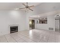 Spacious living room with a fireplace and tile flooring, open to the kitchen area at 533 W Guadalupe Rd # 2126, Mesa, AZ 85210
