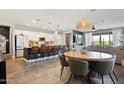 Bright open-concept kitchen with a long island, barstool seating, and a seamless flow into the dining and living areas at 5871 N 187Th Ln, Litchfield Park, AZ 85340