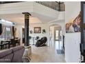 Bright, open floor plan showcasing tile flooring, stairs, decorative pillar, and natural light at 5940 W Robinson Way, Chandler, AZ 85226