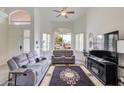 Bright living room with vaulted ceiling, plantation shutters, and comfortable seating area at 5940 W Robinson Way, Chandler, AZ 85226