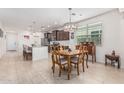 Open-concept kitchen featuring an island with seating, modern appliances, and an adjacent dining area at 607 W Tenia Trl, San Tan Valley, AZ 85140