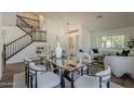 Bright dining area featuring modern furnishings and staircase at 656 W Devon Ct, Gilbert, AZ 85233