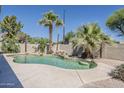 Inviting backyard pool with lush landscaping and waterfall feature at 656 W Devon Ct, Gilbert, AZ 85233