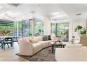 Bright living room with a curved sofa and floor-to-ceiling windows overlooking a garden at 7117 E Rancho Vista Dr # 1012, Scottsdale, AZ 85251