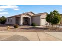 Inviting single-story home with neutral stucco and well-maintained desert landscaping at 7305 W Darrel Rd, Laveen, AZ 85339