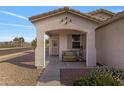 Charming covered porch with a cozy bench, perfect for enjoying the outdoors at 7305 W Darrel Rd, Laveen, AZ 85339