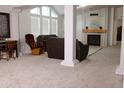 Spacious living room with a fireplace, neutral carpet, and vaulted ceilings provides a cozy gathering space at 8902 E Baltimore St, Mesa, AZ 85207
