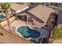 Aerial view showcasing a backyard oasis with a sparkling pool, patio area, and mature trees offering privacy at 9632 E Olla Ave, Mesa, AZ 85212