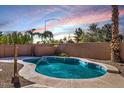 Sparkling backyard pool featuring desert landscaping and privacy fence, perfect for outdoor enjoyment at 9632 E Olla Ave, Mesa, AZ 85212