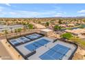 Aerial view of pristine blue tennis courts in a well-maintained community at 10377 W Yukon Dr, Peoria, AZ 85382