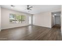 Bright living room with wood-look floors, a ceiling fan and lots of natural light at 105 E Hermosa Dr, Tempe, AZ 85282