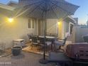 Enjoy the backyard patio with ample seating, a patio umbrella, and a built-in grill at 1055 N 86Th Pl, Scottsdale, AZ 85257
