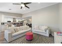 Bright living room with modern sofas that opens into the kitchen and dining area at 1055 N 86Th Pl, Scottsdale, AZ 85257