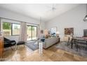 Open living room with high ceilings, tile floors, and sliding glass doors to the patio at 1124 E Rose Ln # 17, Phoenix, AZ 85014