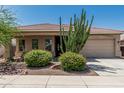 Charming single-story home with well-manicured desert landscaping and a two-car garage at 12417 W Apache St, Avondale, AZ 85323