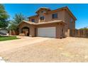 Spacious home featuring an arched porch, two car garage and low maintenance landscaping at 1250 E Canyon Creek Dr, Gilbert, AZ 85295