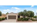 Welcoming single-story home featuring desert landscaping, a two-car garage, and a charming street lamp at 13414 W San Pablo Dr, Sun City West, AZ 85375