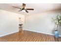 Spacious living room featuring wood-look floors and a view into the next room at 1413 W 7Th Pl, Tempe, AZ 85281