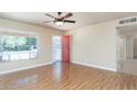 Bright living room with wood-look floors and a red front door, creating an inviting space at 1413 W 7Th Pl, Tempe, AZ 85281