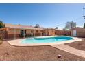 Relaxing backyard featuring a sparkling in-ground pool and covered patio, ideal for outdoor living at 1413 W 7Th Pl, Tempe, AZ 85281